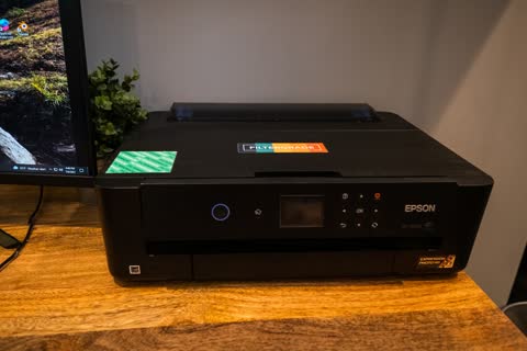 Epson inkjet printer on a wooden desk