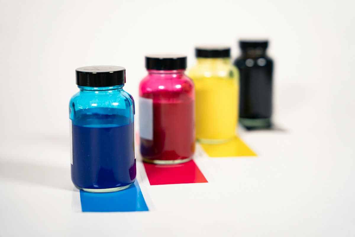 Bottles of cyan, magenta, yellow and black printer ink