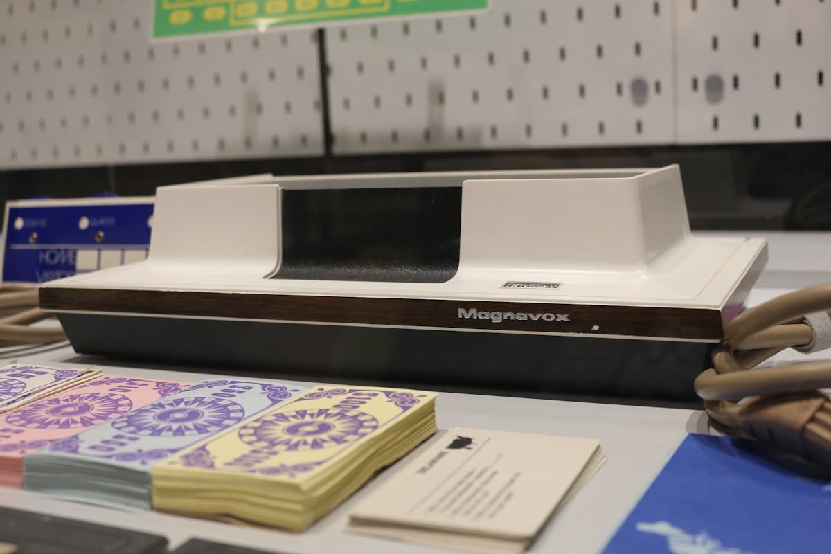 A printer sitting on top of a table next to a pile of papers