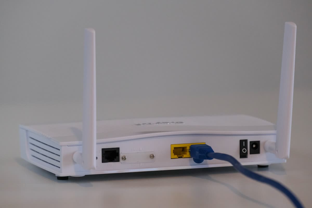 White wireless router with a network cable plugged in