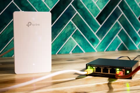 A wi-fi router and a network switch sit side-by-side