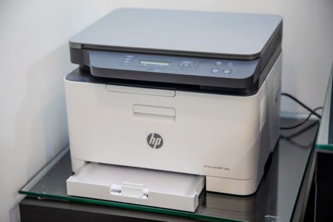 HP Color Laser MFP on a glass side table