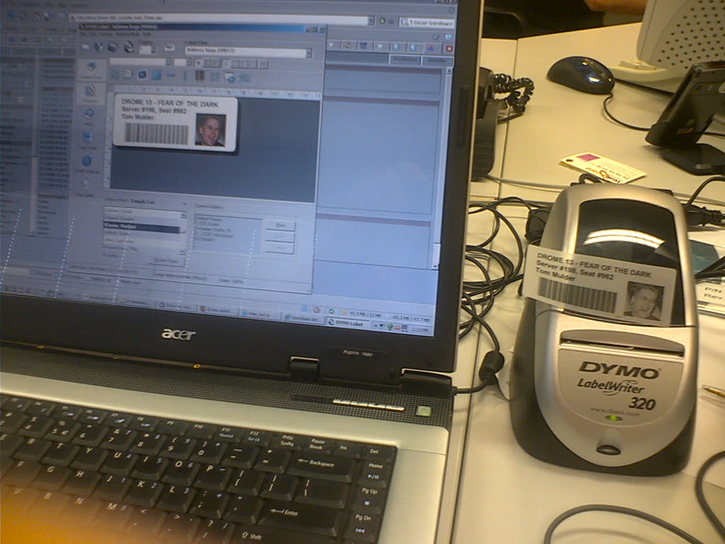 DYMO LabelWriter label printer next to a laptop running label software