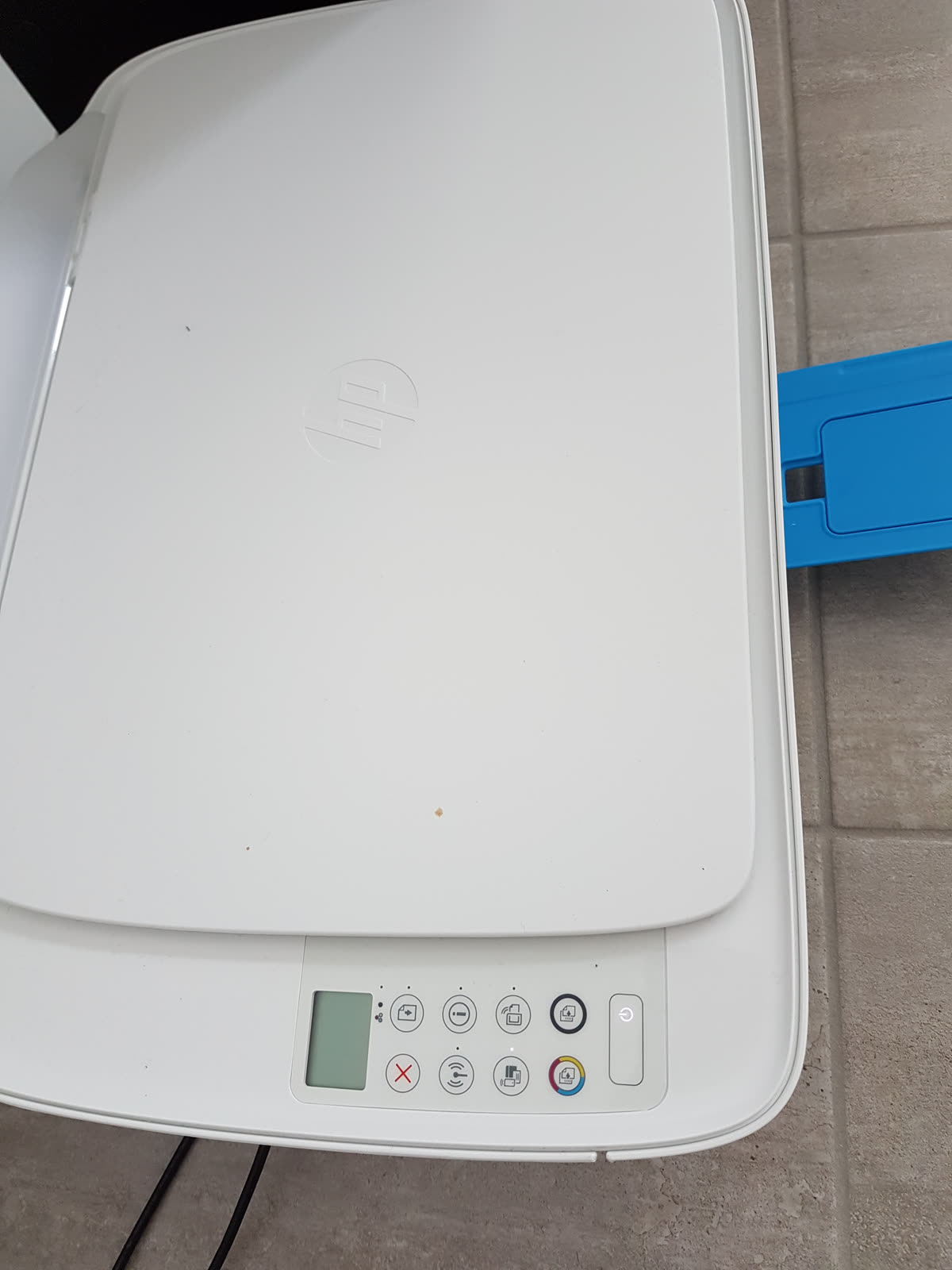Top of a white HP inkjet printer and its control panel