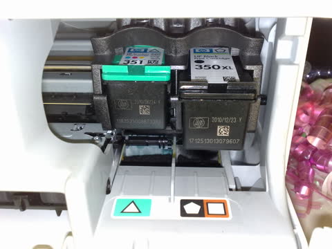 HP ink cartridges installed in the printer's cartridge carriage