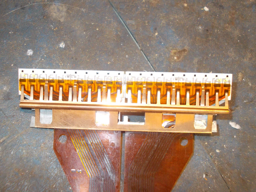 Print head removed from a printer, showing its contacts
