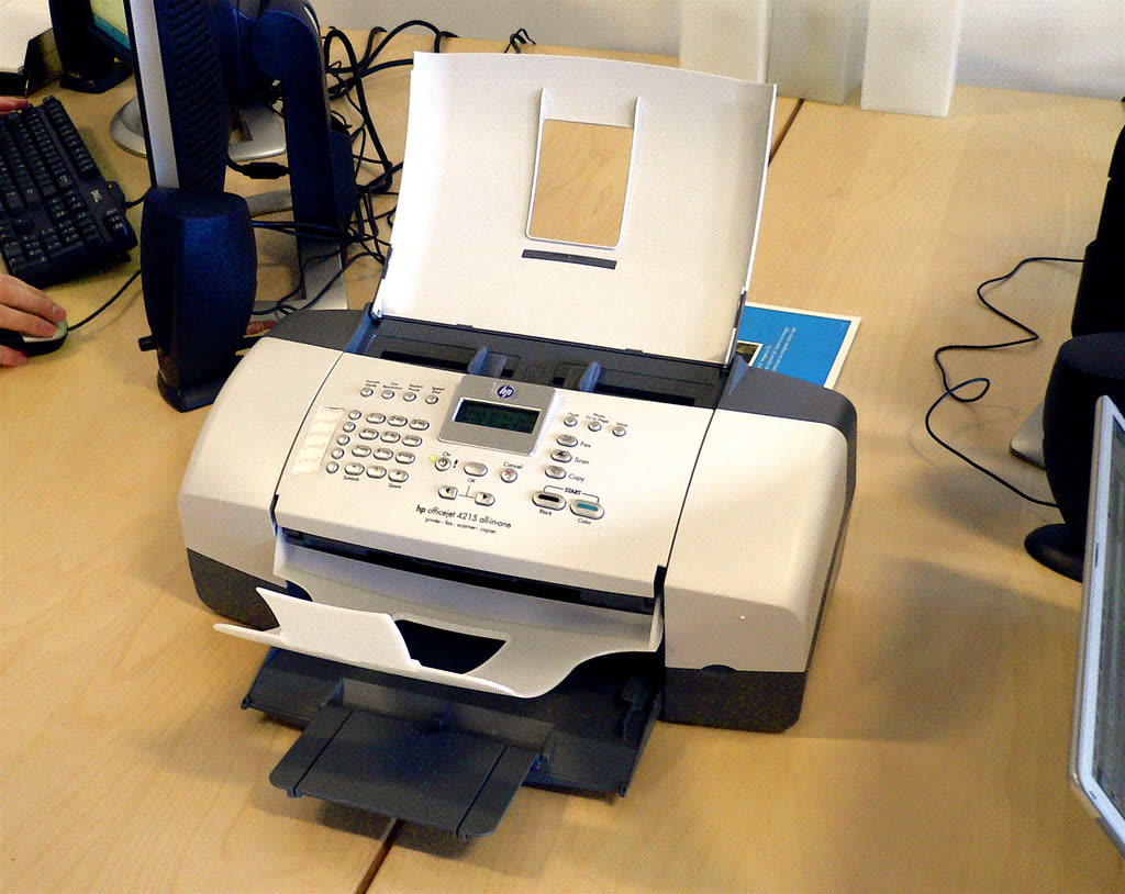 HP Officejet all-in-one printer with fax on an office desk